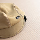 snek cycling hardface winter cap coyote brown detail of brim and snek label