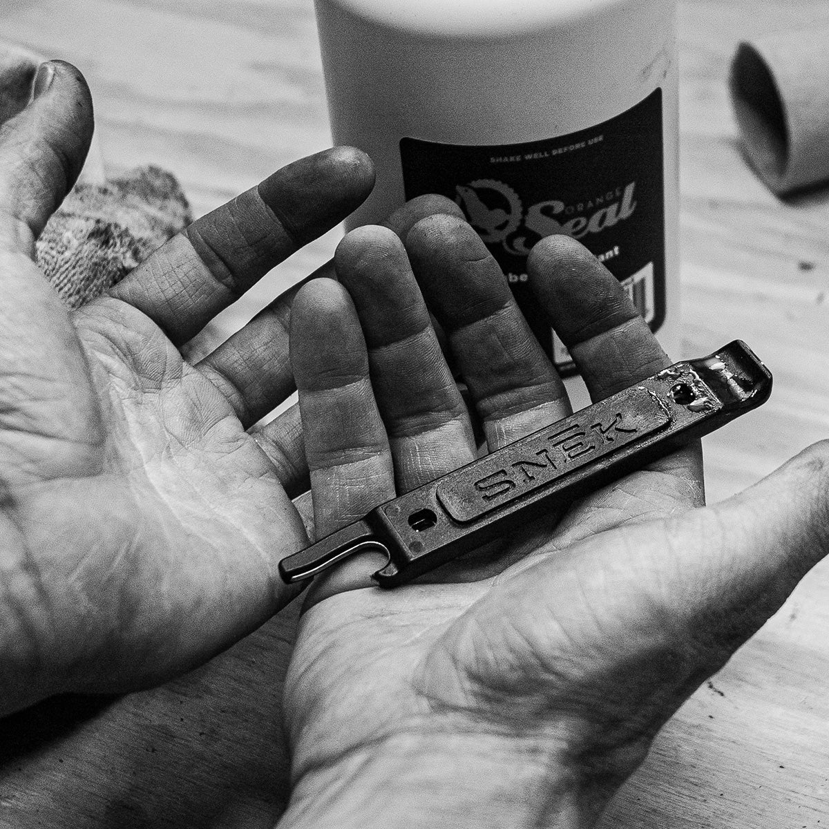 snek cycling lifeboat tire lever and valve core remover detail of dirty hand after tubeless tire repair