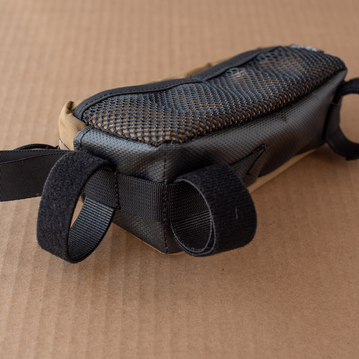 front side of the bottom of top tube bag with webbing slots