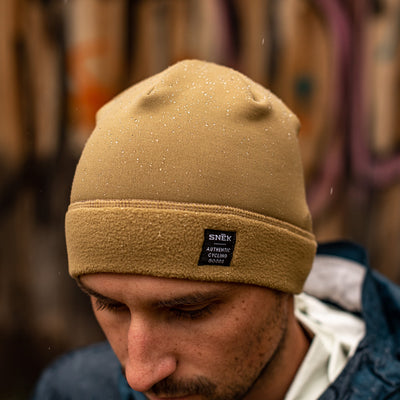 Model wearing the hardface polartec beanie with water repellant finish and water drop beads