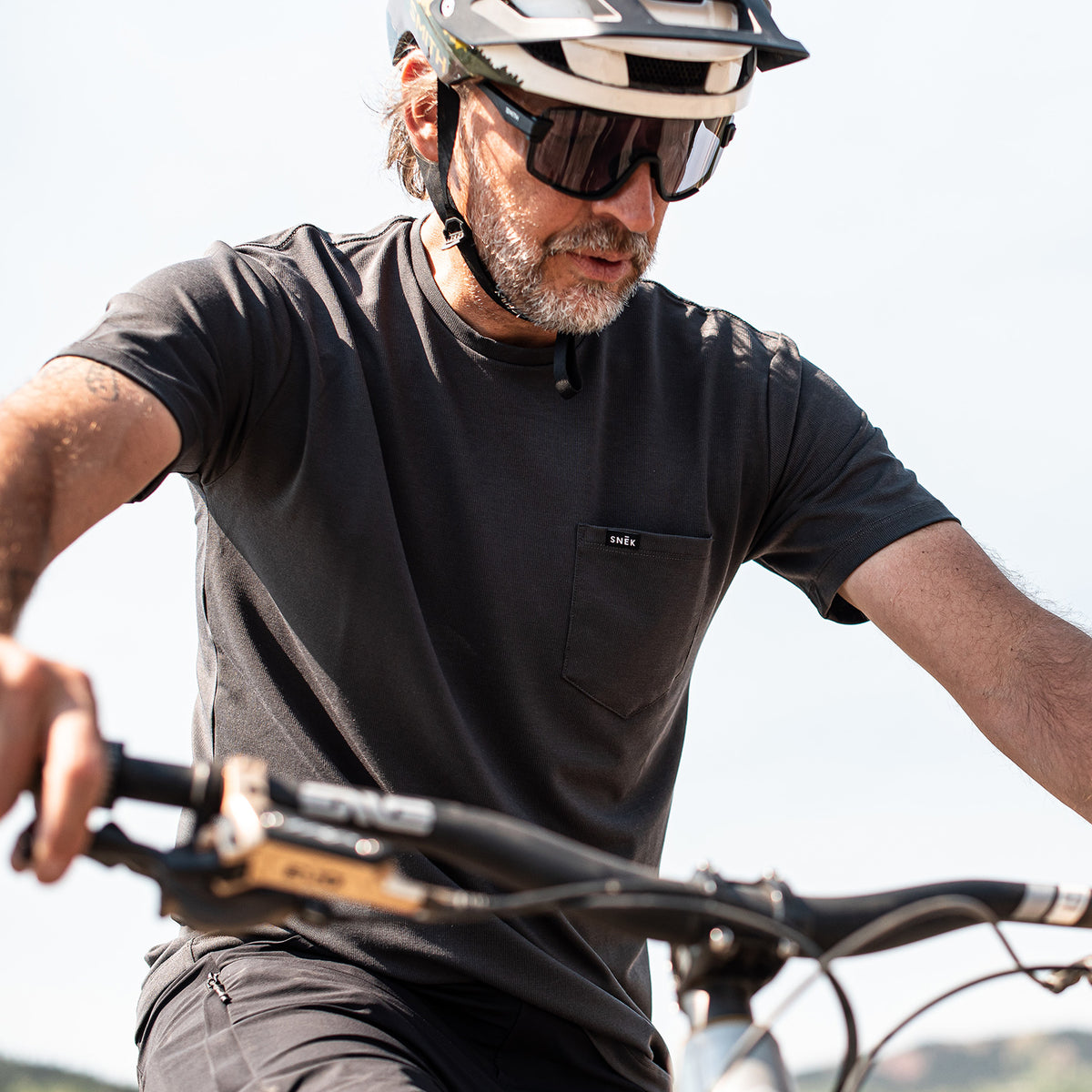 snek cycling mountain biker in the dry creek tee shirt jersey with enve handlebar and yeti bike