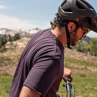 snek cycling purple tee and mountain bike jersey on model with shoulder and construction detail