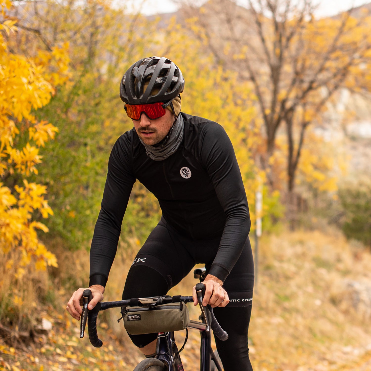 snek cycling beanie and handlebar bag riding photo with fall colors in salt lake city utah